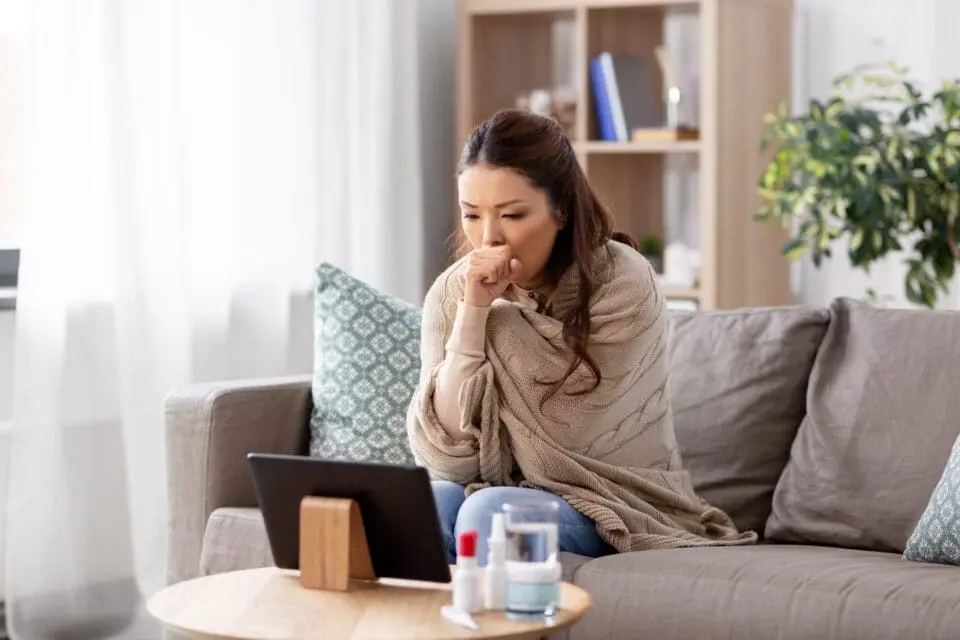 sick woman having video call on tablet pc at home with telehealth doctor