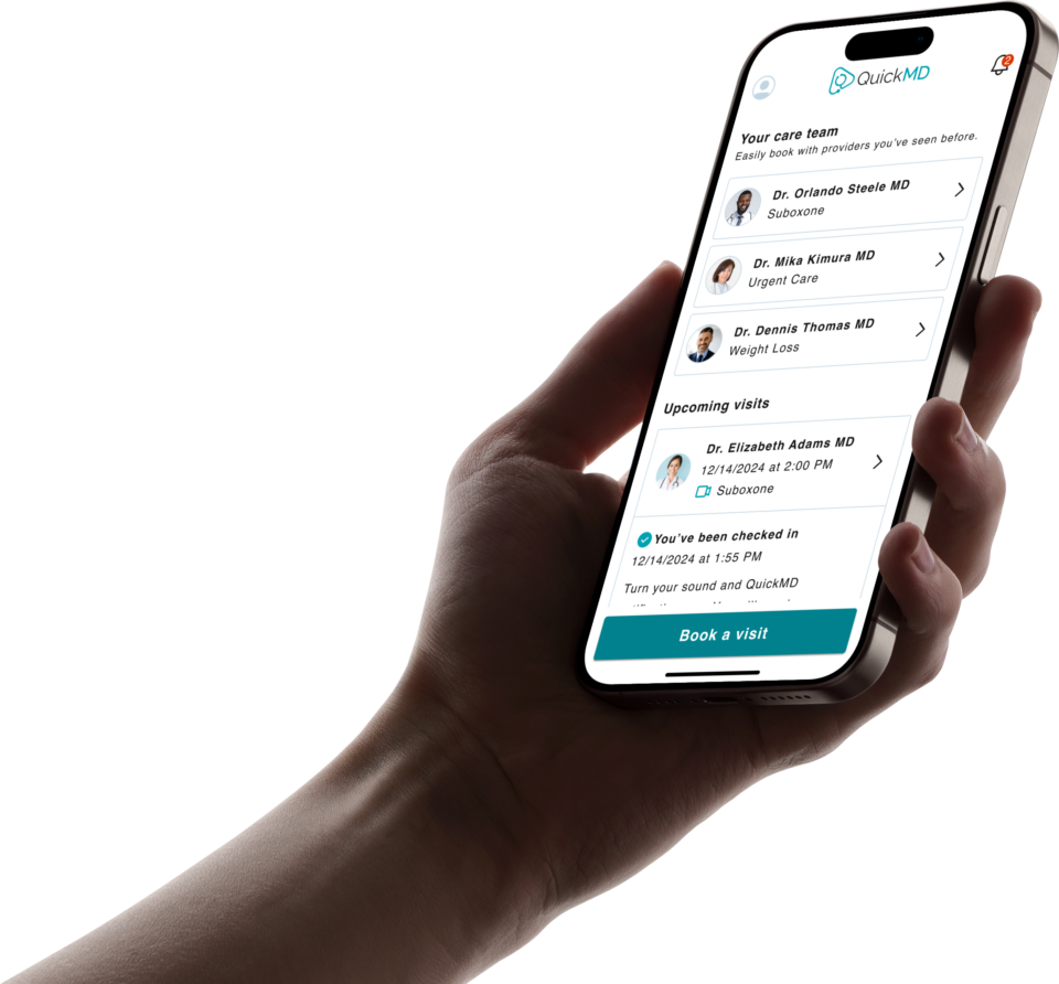 Hand holding iphone using the Quick MD Mobile App to schedule an appointment