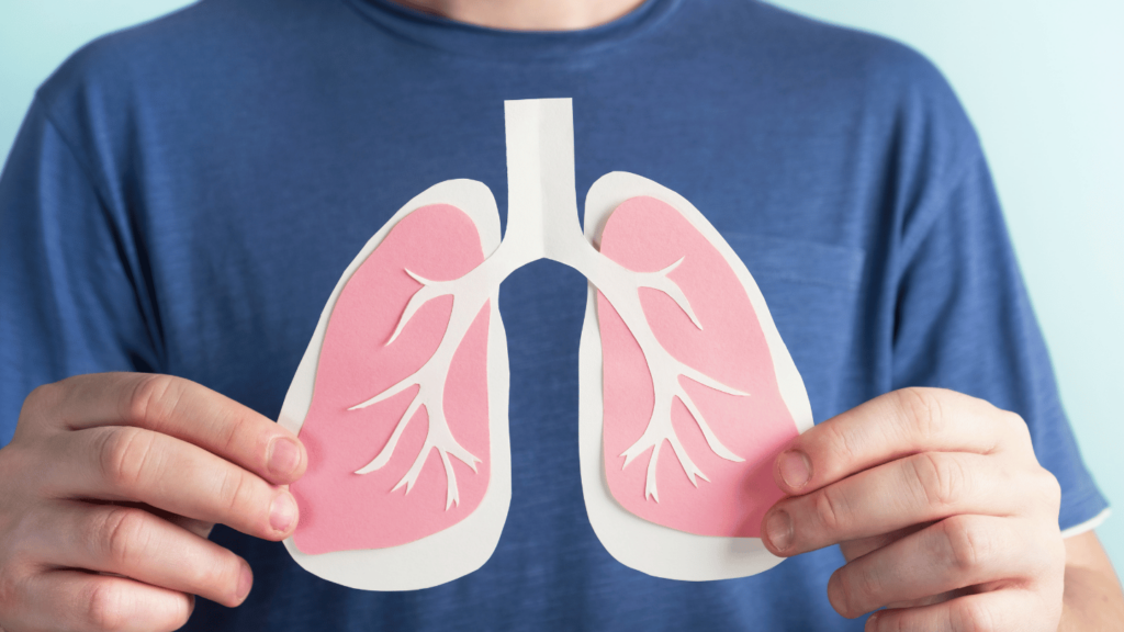 Man holding up diagram of lungs