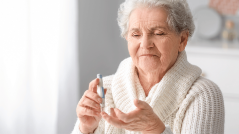 Woman with Type 2 diabetes measuring her blood sugar