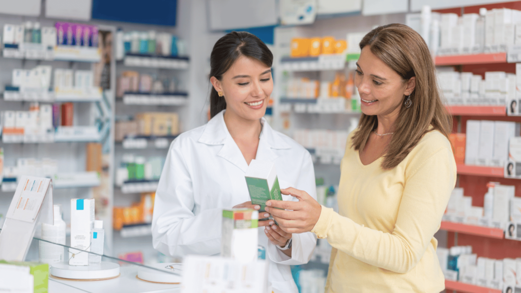 A pharmacist assisting a customer with information about weight loss injection costs at a pharmacy counter|QuickMD doctor calculating the cost of Mounjaro without insurance