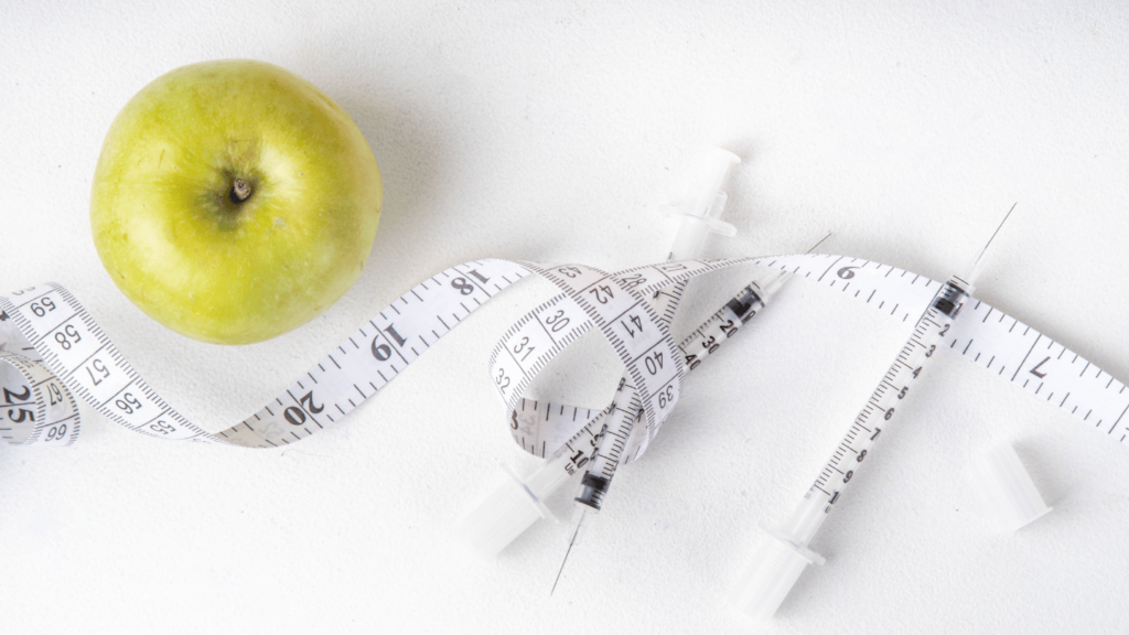 Apple and measuring tape next to syringes of semaglutide vs. compounded semaglutide