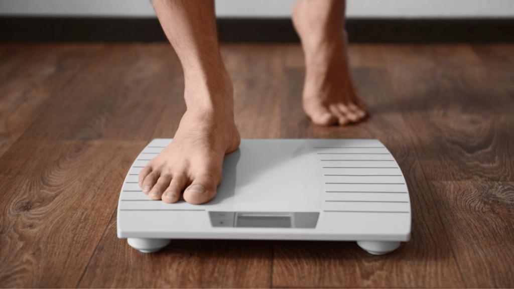 Close-up of a person stepping onto a digital scale