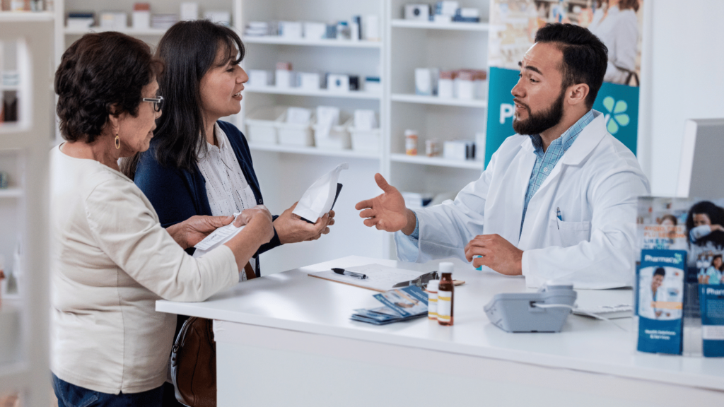 Pharmacist explaining Wegovy side effects to two women