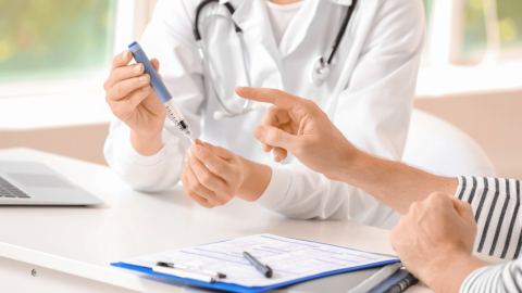 Doctor comparing Ozempic injection pen with treatment options like Metformin during a diabetes consultation