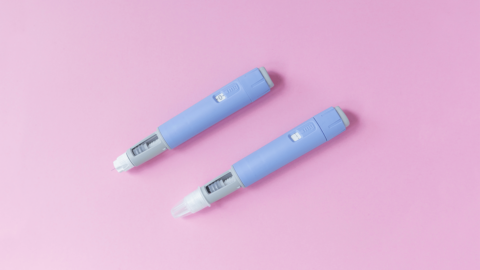 Victoza and Ozempic injection pens side by side on a pink background