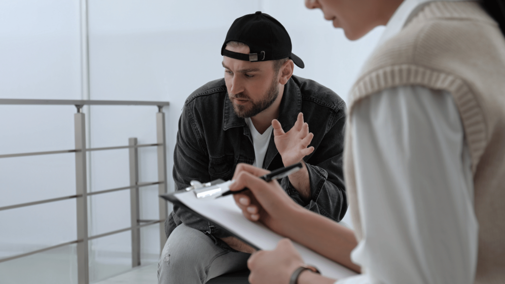 Man discussing opioid addiction treatment options with a healthcare provider during a consultation