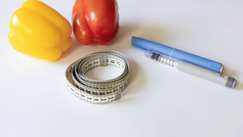 Semaglutide injection pen with measuring tape and fresh vegetables