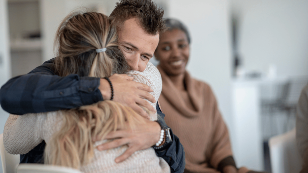 Man hugging a woman after recovery from opioid use disorder using Suboxone