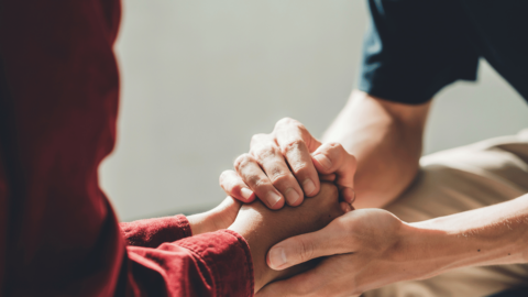 Two people holding hands, representing getting help with opioid addiction resources