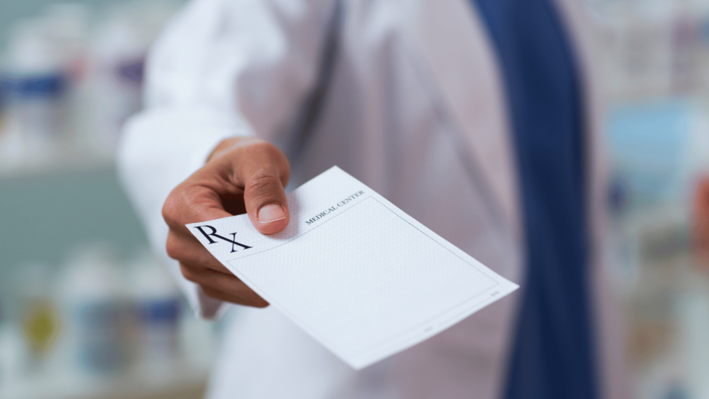 Pharmacist giving a prescription paper