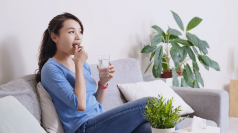 Woman on couch taking Rybelsus