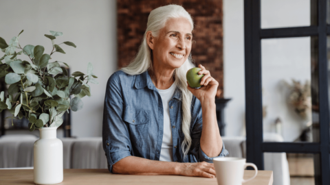 Older woman eating an apple