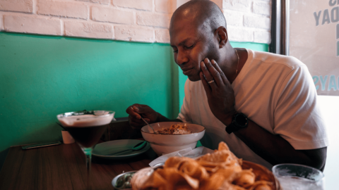 Man having tooth pain while eating