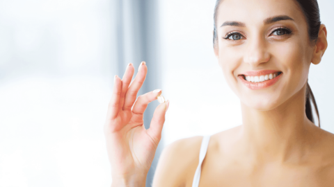 Woman holding a pill representing Suboxone