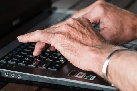 Person typing experiencing gout flares