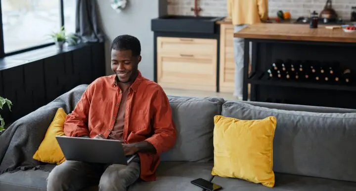 Man on couch doing a virtual telehealth visit