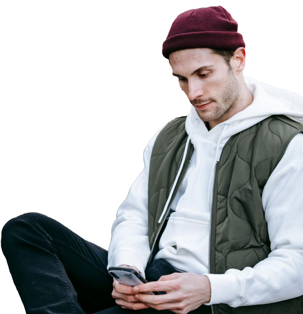 man with red beanie sitting and booking an appointment on QuickMD for opioid addiction