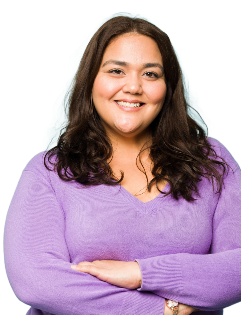 woman in purple shirt with arms crossed and smiling