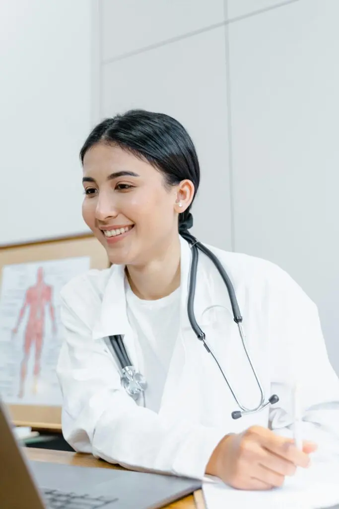 woman doctor speaking with patient on video call