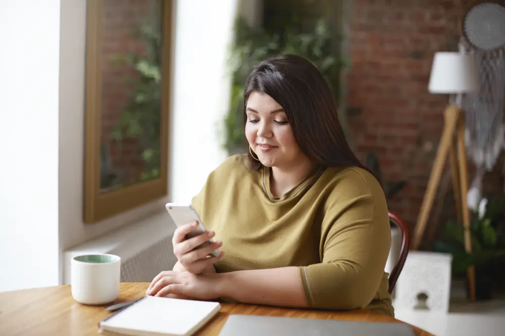 Patient researching the difference between brand and non-brand weight loss injections|A pharmacist assisting a customer with information about weight loss injection costs at a pharmacy counter