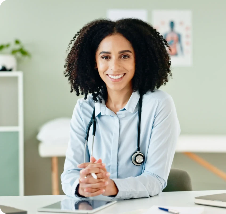 Doctor sitting in her office with a stethoscope around her neck