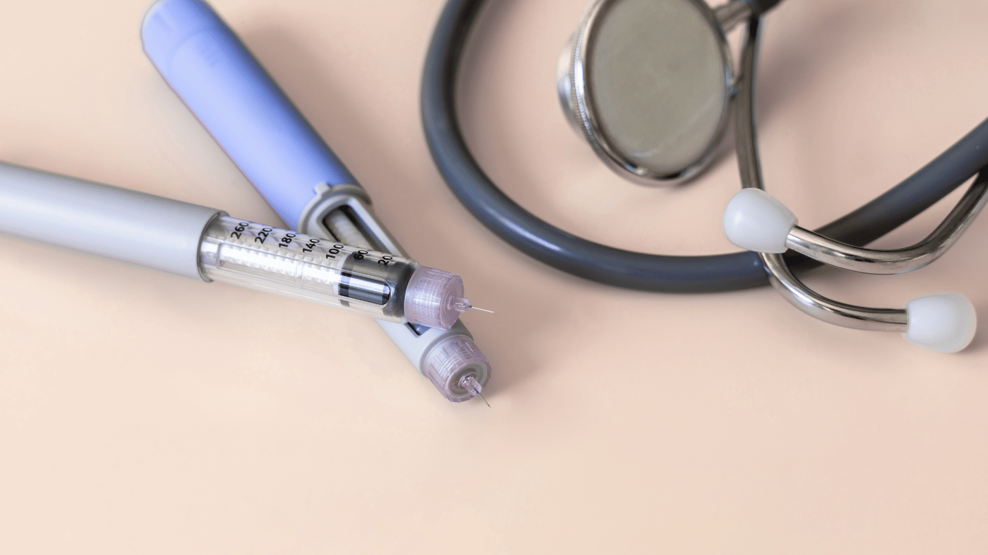 Ozempic injection pens and a stethoscope on a neutral background, symbolizing diabetes management and medical care